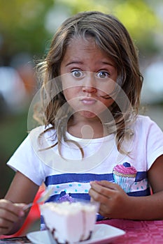 portrait of a beautiful 4 year old girl who makes funny faces