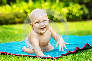 Portrait of a beautiful 6 months baby smiling outdoor. Cute Child on the background of nature