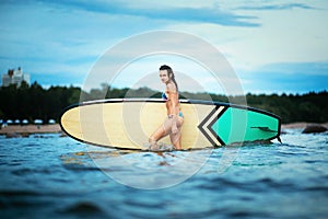 Portrait of beautiful active woman spending summer holidays on the beach, enjoying surfing, Bali, Indonesia