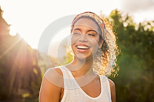 Young african woman smiling at sunset