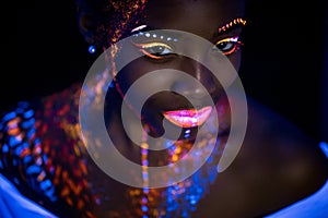 Portrait of beautiful african fashion model in neon UF light