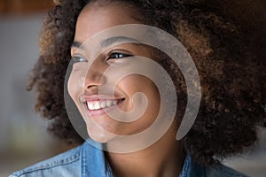 Portrait of beautiful African teenage girl staring aside feeling happy