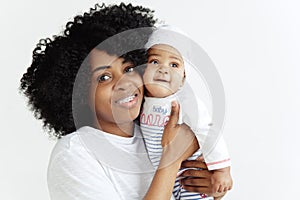 Portrait of beautiful african woman holding on hands her little baby