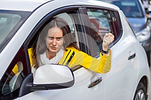 Portrait of beautiful angry woman driver.