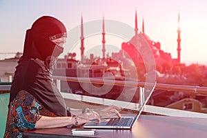 Portrait of beautiful Arabian Woman working on Computer