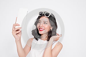 Portrait of beautiful asian fashionable girl taking selfie