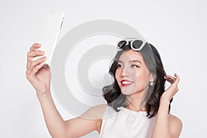 Portrait of beautiful asian fashionable girl taking selfie