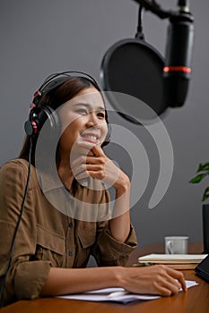 Portrait, Beautiful Asian female online radio host or podcaster running her show