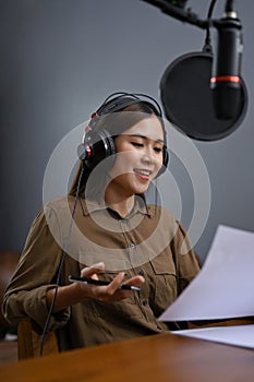 Portrait, Beautiful Asian female recording her podcast contents or online radio in her studio