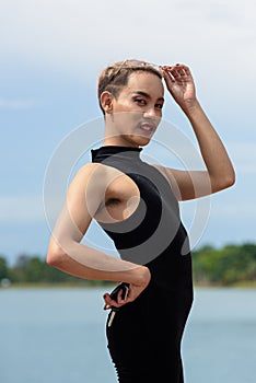 Beautiful Asian queer LGBT community supporter man with mustache wearing lipstick and jumpsuit photo