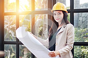 Portrait of beautiful Asian woman architect builder with yellow