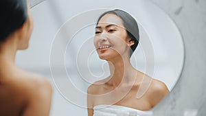 Portrait of Beautiful Asian Woman Checking her Clean Naturaly White Teeth, Smiles in Bathroom Mirr