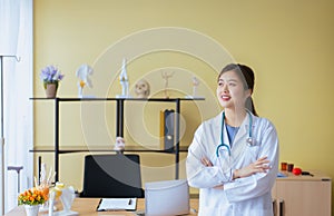 Portrait of beautiful asian woman doctor cross arm and standing at hospital,Happy and positive attitude thinking