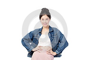 Portrait of beautiful asian woman model in white T-shirt, dressed in denim jacket posing while standing and looking at camera