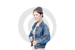 Portrait of beautiful asian woman model in white T-shirt, dressed in denim jacket posing while standing and looking at camera