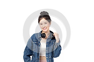 Portrait of beautiful asian woman model in white T-shirt, dressed in denim jacket posing while standing and looking at camera