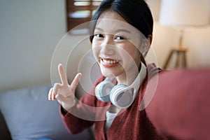 Portrait of beautiful Asian woman selfie with smiling face and showing signs of encouragement