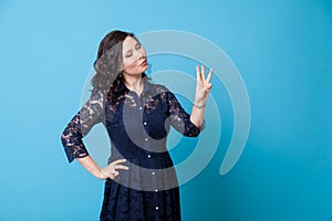 Portrait of a beautiful Asian woman shows three fingers on her hand