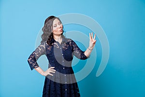 Portrait of a beautiful Asian woman shows three fingers on her hand