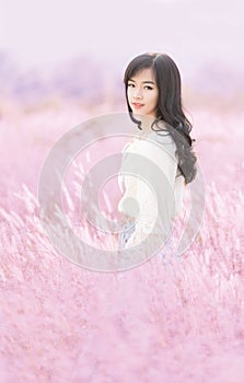Portrait of a beautiful asian woman smiling in meadow.Beautiful sexy asian girl on romantic grass field background