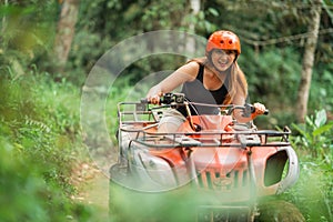 portrait of a beautiful asian woman smiling while riding the atv