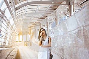 Portrait beautiful asian woman using cellphone and walking in the city,Female confidence happy and smiling,Lifestyle concept