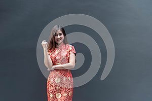 Portrait of a beautiful Asian woman wearing a red cheongsam