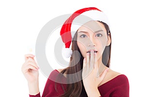 Portrait of beautiful asian young woman in santa hat smile holding credit card.