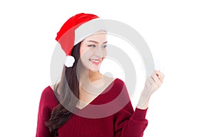 Portrait of beautiful asian young woman in santa hat smile holding credit card