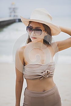 Portrait of beautiful asian younger woman toothy smiling face with happiness emotion at sea beach