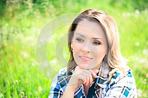 Portrait of a beautiful attractive woman outdoors in the summer