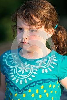 Portrait of beautiful attractive young girl thinking outside at sunset