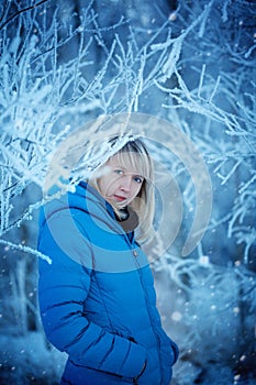 Portrait Beautiful Attractive Young Woman in Wintertime outdoor in the snow-covered wood.