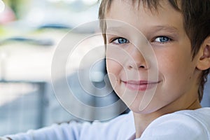 Portrait of a beautiful baby boy model in white clothes with a kind look,