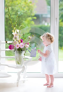 Portrait of a beautiful baby girl with fresh flowers