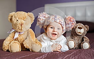 Portrait of a beautiful baby with plush toys