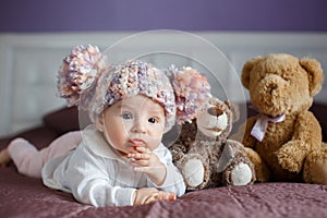 Portrait of a beautiful baby with plush toys