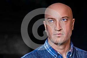 Portrait of a beautiful bald man with blue eyes