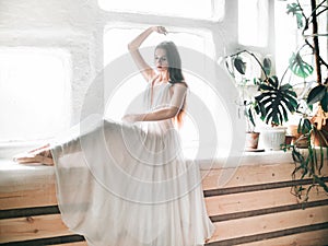 Portrait  of beautiful  balerina woman weared in white dress photo