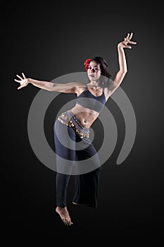 Beautiful belly dancer performing in the studio