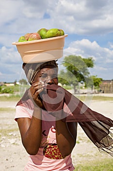 Portrait of beautiful black African women with fruits on her head, Botswana