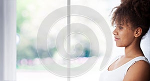 Portrait of beautiful black woman. Atractive brunette dark-skinned woman in a white tank top.