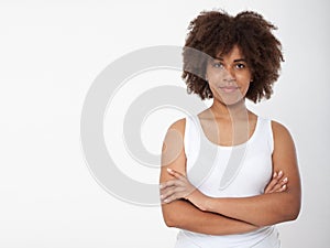 Portrait of beautiful black woman isolated. Atractive brunette dark-skinned woman in a white tank top.