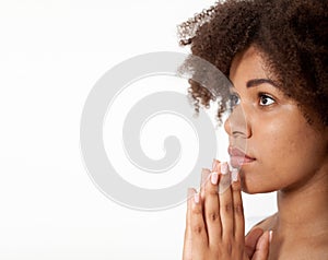 Portrait beautiful black woman praying, young girl with her hands together, closeup expression. Religion faith and