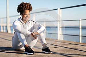 Portrait Of Beautiful Black Woman In Sportswear Relaxing After Training Outdoors