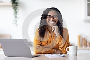 Portrait of beautiful black woman working on laptop