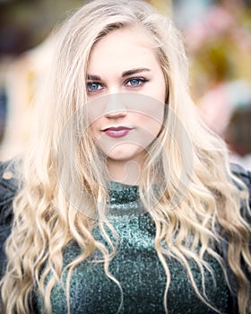 Portrait of a Beautiful Blond Blue Eyed Teenage Girl in Green To