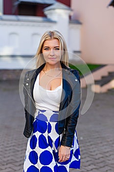 Portrait of a beautiful blonde in blue skirt