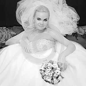 Portrait of beautiful blonde bride with great vapory veil