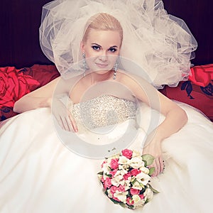 Portrait of a beautiful blonde bride with great vapory veil